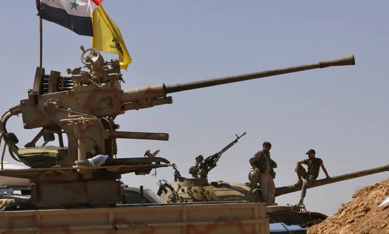 Syrian tanks and soldiers in a desert landscape, possibly related to military operations.