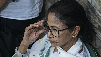 Mamata Banerjee adjusting her glasses during a public event in Kolkata.