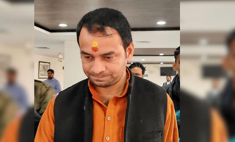 Tej Pratap Yadav at an indoor event, wearing traditional attire with a tilak on his forehead.