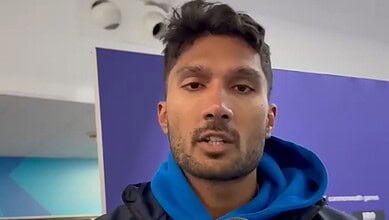 Indian athlete Tejaswin Shankar in a sports facility, wearing a blue hoodie.