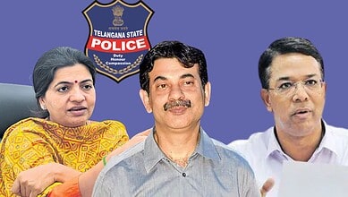 Telangana police officials discussing monsoon preparedness in front of police badge.