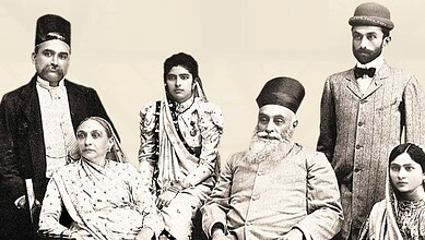 Historical photograph of a family in traditional Indian attire, including men, women, and children.