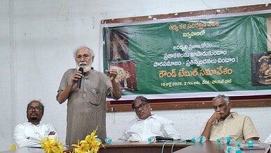 The image shows Adi Dhwani Trust founder and retired professor Jayadheer Tirumala Rao addressing a round-table meeting at Sundarayya Vignana Kendram on Friday, July 10, 2026.