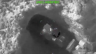Unidentified object in snowy terrain captured by drone, marked as 'UNCLASSIFIED'.