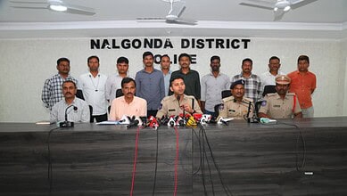 Group of officials and police officers at a press conference in Nalgonda District, India.