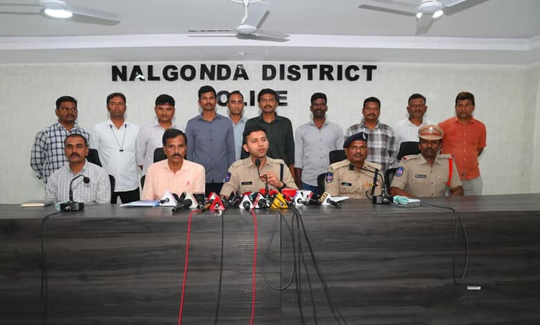 Group of officials and police officers at a press conference in Nalgonda District, India.