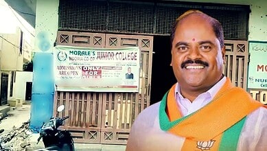 Smiling man in traditional attire standing outside a college building in Hyderabad.