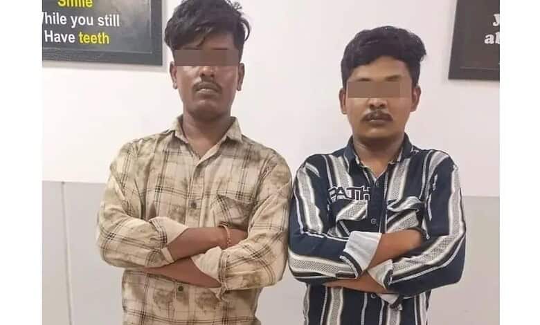 Two young men with crossed arms standing indoors, faces obscured, in Hyderabad.