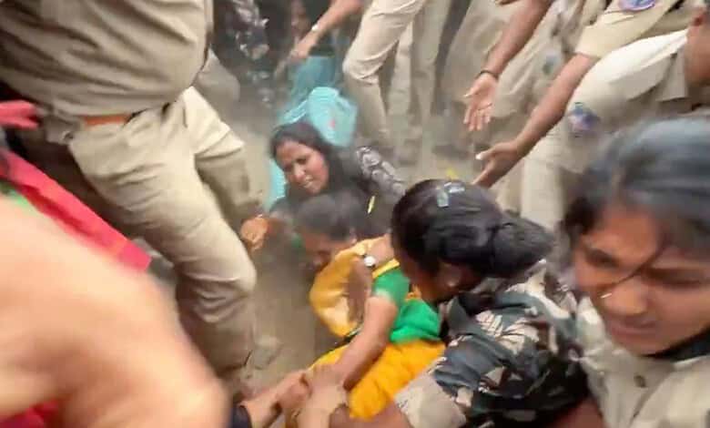 Protesters and police clash during Hyderabad demonstration, chaos and dust in the scene.