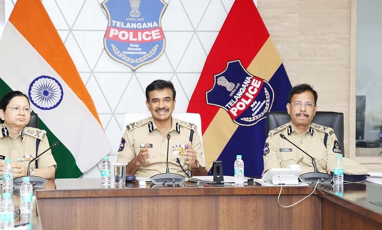 Telangana Police officials at a press conference with Indian and Telangana flags in the background.