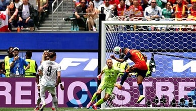 A Spanish player attempts a header