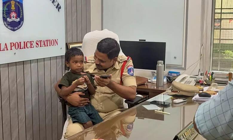 Police officer with young boy at Metla Police Station, India, during rescue operation.