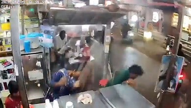 Gas station scene with people near a LPG cylinder explosion in Telangana's Suryapet.