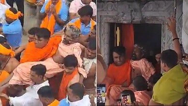 Hindu religious ceremony with priests and devotees inside a temple, performing rituals.