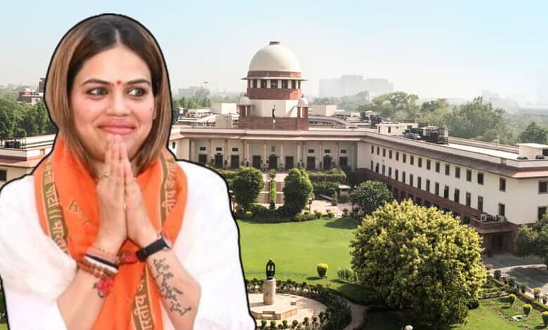 Indian woman in traditional attire with hands folded in front of the Supreme Court of India.