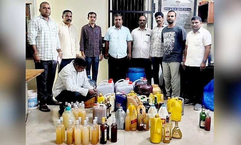 Group of men standing behind a collection of various bottles and containers in an indoor setting.