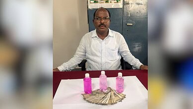 Mahabubnagar officer with bribe money and pink bottles, caught by Telangana ACB.