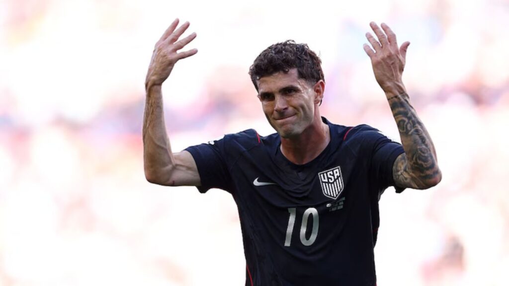 Messi in US national team jersey celebrating with hands raised during match.