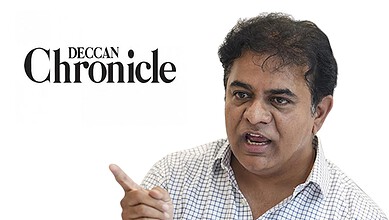 Indian man speaking passionately, pointing with his finger, in a professional setting.