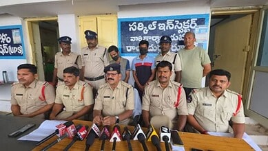 Andhra Police officers and suspects during a press conference about a murder case.