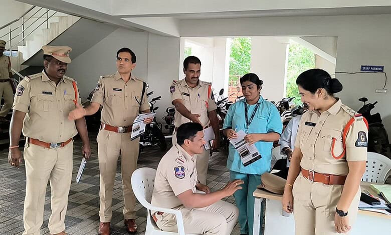 Police officers and medical staff engaged in a discussion in a parking area.
