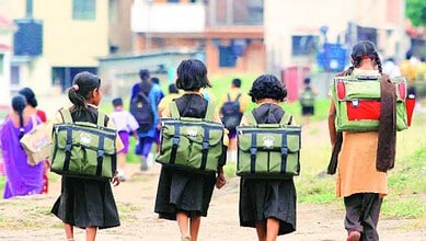 School children with backpacks walking outdoors during a school closure in Telangana.