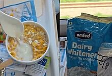 A bowl of cornflakes with spoiled milk and a spoon, on a train tray table.