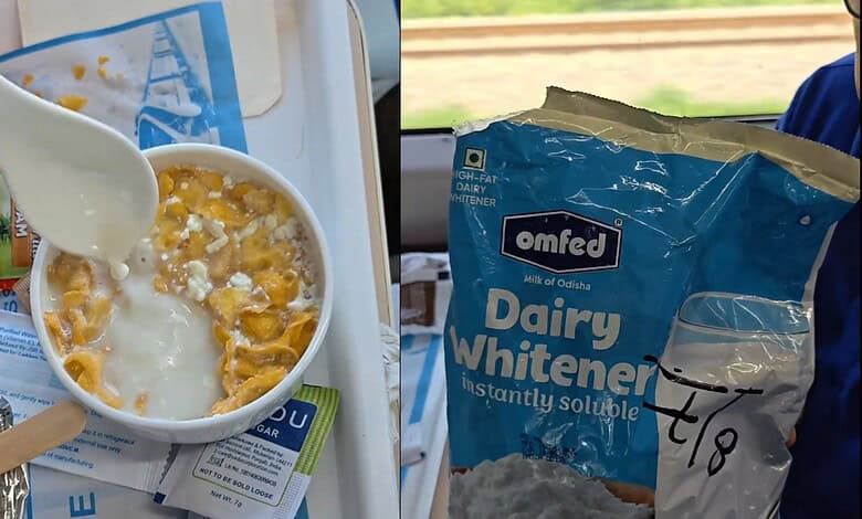 A bowl of cornflakes with spoiled milk and a spoon, on a train tray table.