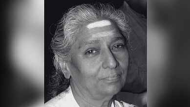 Black and white portrait of veteran playback singer S Janaki with a gentle smile.