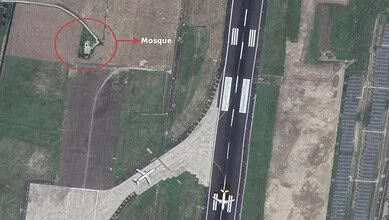 Aerial view of Kolkata airport runway with mosque nearby, marked with a red circle.