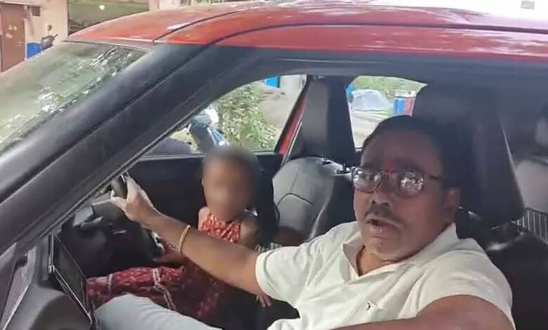 Man driving car with young girl in passenger seat, blurred face, in Hyderabad.