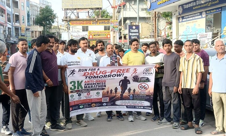 Group of people participating in a drug-free marathon awareness event on a busy street.