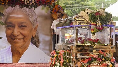 Tribute to S Janaki with floral arrangements and a portrait at her cremation in Mysuru.
