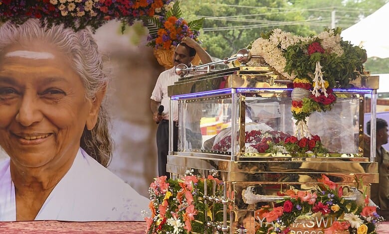 Tribute to S Janaki with floral arrangements and a portrait at her cremation in Mysuru.