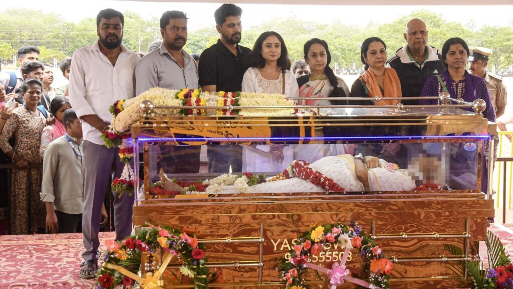 Mourners gather around the coffin of S Janaki during her cremation in Mysuru.