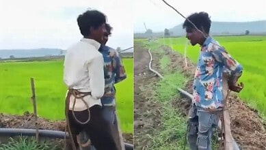 Two young boys in colourful shirts stand in a green paddy field in Madhya Pradesh.