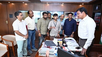 Group of officials discussing in office during the launch of online fire NOC portal.