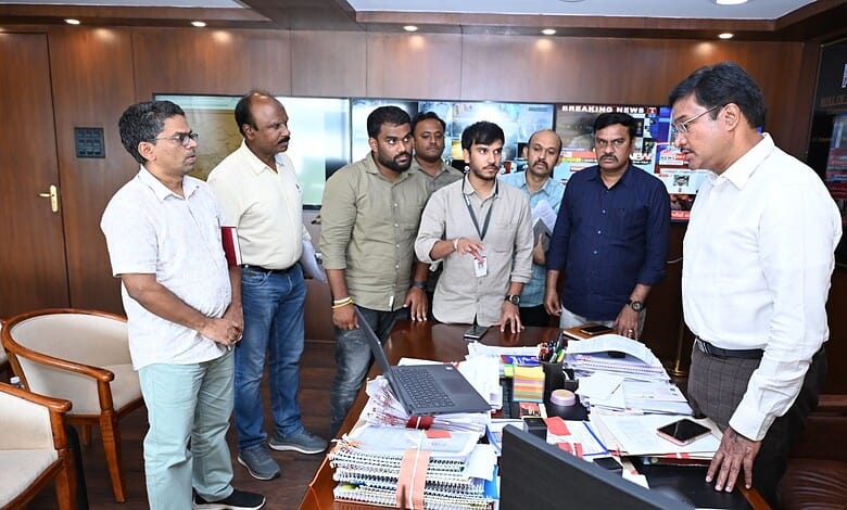 Group of officials discussing in office during the launch of online fire NOC portal.