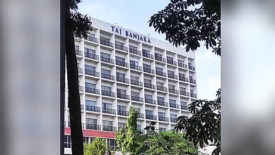 Taj Banjara hotel building in Hyderabad with multiple balconies and trees in foreground.