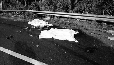 Scene of a fatal accident on Hyderabad's Outer Ring Road with body covers on the road.