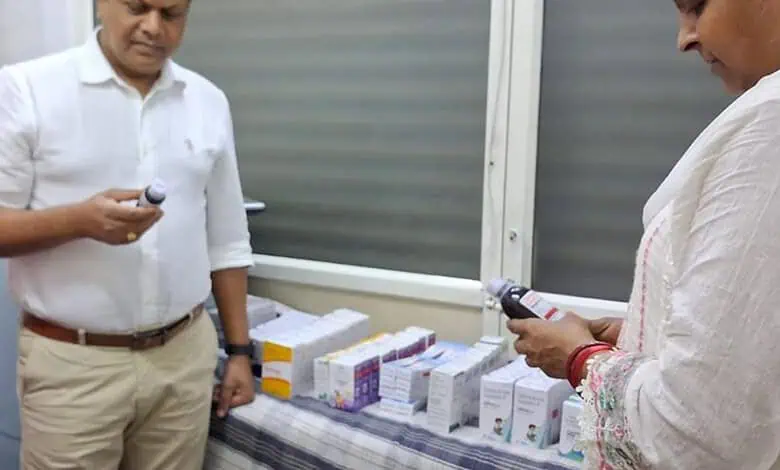 Officials inspecting seized illegal medicines displayed on a table in Chandrayangutta.