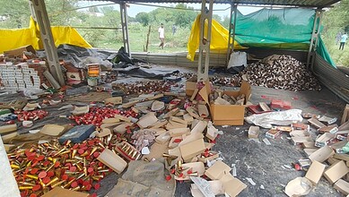 Explosion site with scattered firecrackers and debris after blast at illegal firecracker unit.