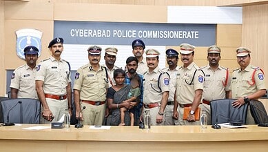 Cyberabad police officers with two children at police station in Hyderabad, India.