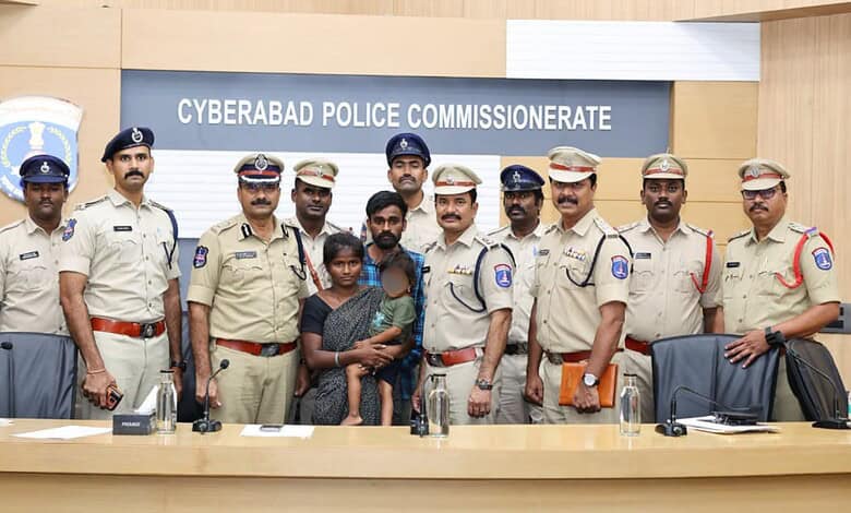Cyberabad police officers with two children at police station in Hyderabad, India.
