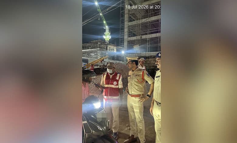 Police officers inspecting a motorcycle at night during a crackdown in Cyberabad.