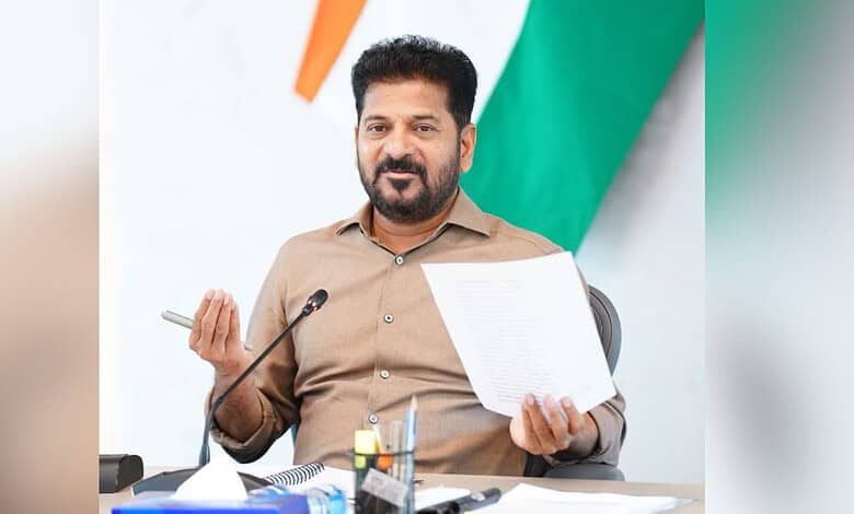 Telangana official holding a document during a press conference in Hyderabad.