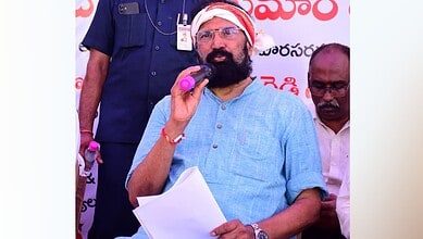 Man speaking at a public event during the Kaleshwaram barrage repairs testing.