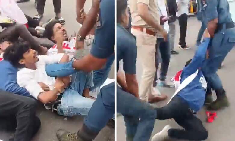 Clash between police and protesters on the street, with people on the ground and officers involved.