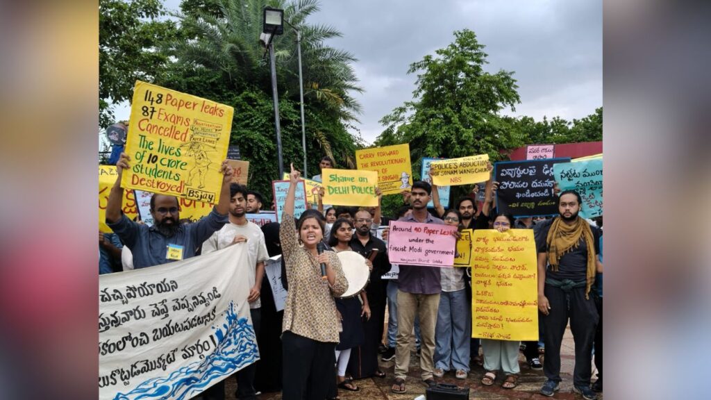 Protesters in Hyderabad hold signs demanding action and accountability from the government.