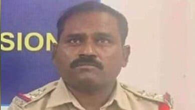 Police officer with a serious expression in uniform, related to Warangal CP suspension news.